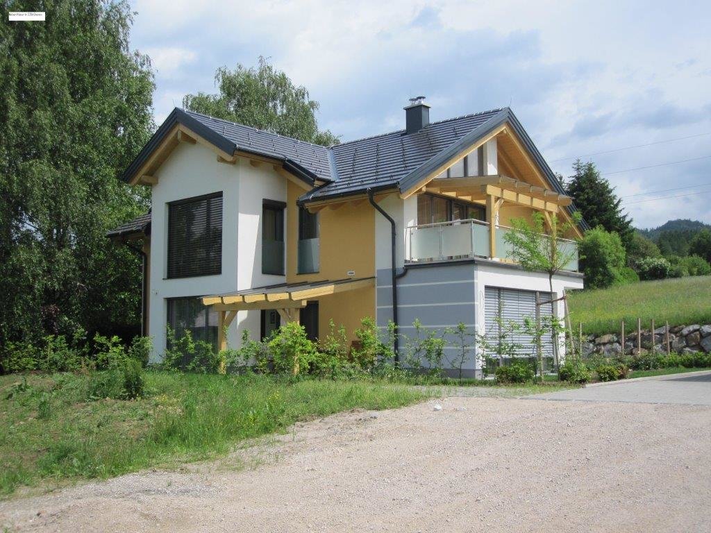 Kleines Haus auf dem Land mit dunklen Ziegeln und hellem Dachstuhl